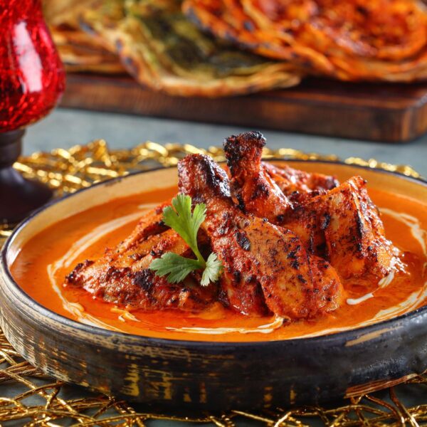 Tandoor grilled chicken tikka simmered in satin, smooth tomato gravy rich in cashew and made piquant with dried fenugreek – Punjab Grill