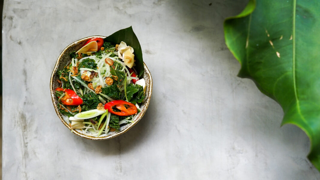 Rumpu Rampe Flores, a plant-based dish made from young papaya, banana blossoms, and fern leaves at John Hardy's The Long Table Seminyak