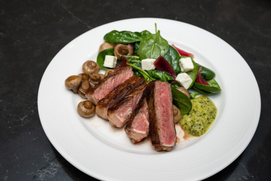 Irish Black Angus Striploin with Chimichurri Sauce, Sauteed Mushrooms and Seasonal Salad