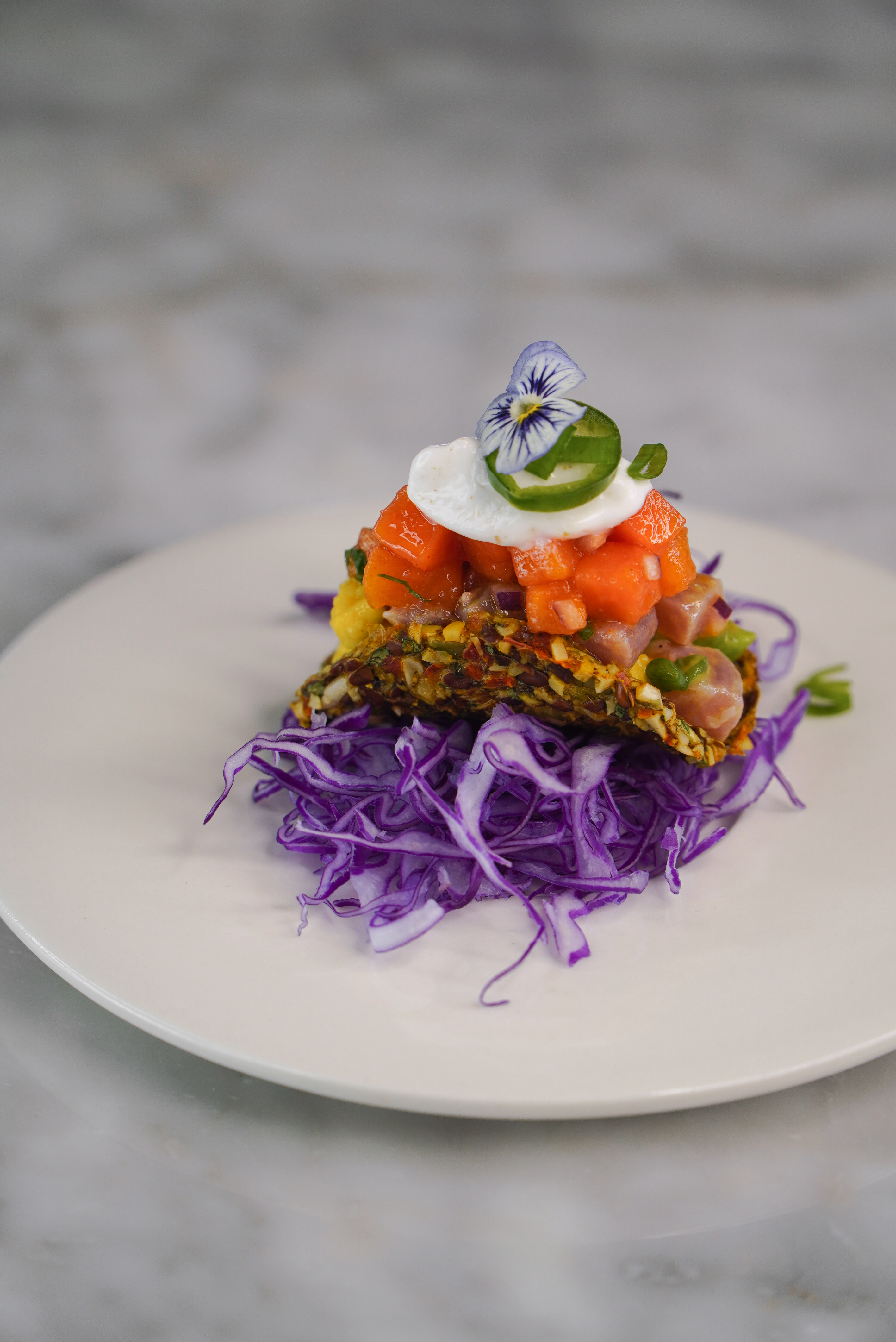 Spice raw tuna and avocado on flaxseed tacos, papaya salsa and coconut yoghurt