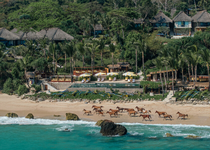 NIHI Sumba: Sumbanese horseman riding a Sandalwood pony into the surf at NIHI Sumba