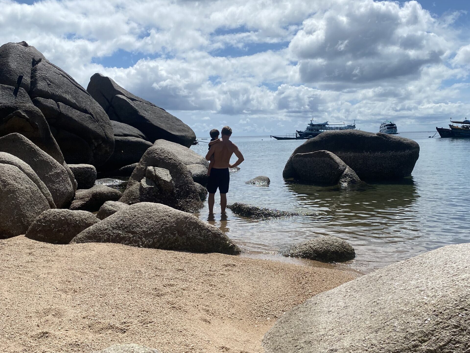 Family at the rocky shoreline of Koh Tao Thailand — family travel in Southeast Asia