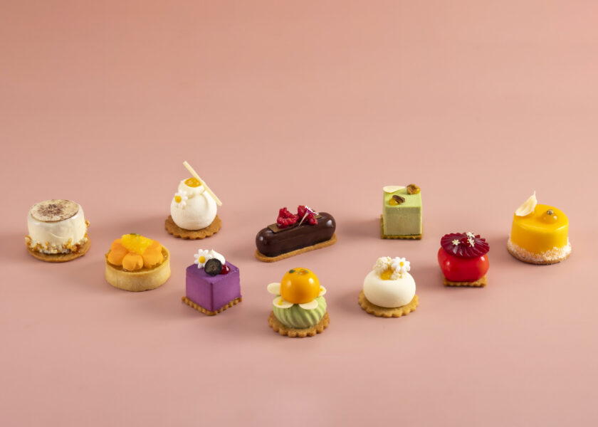 An assortment of miniature pastries and desserts presented as part of the Fine Brunch Patisserie at Raffles Jakarta.
